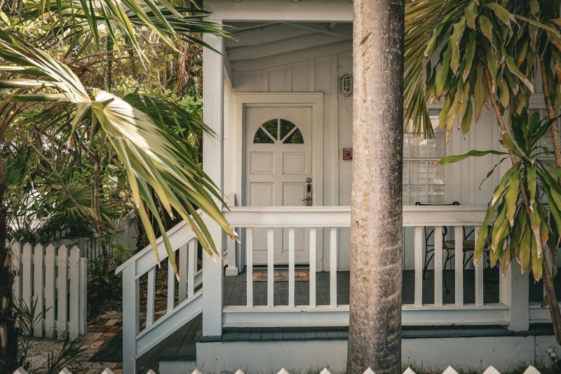 Charming tropical front porch with palm trees